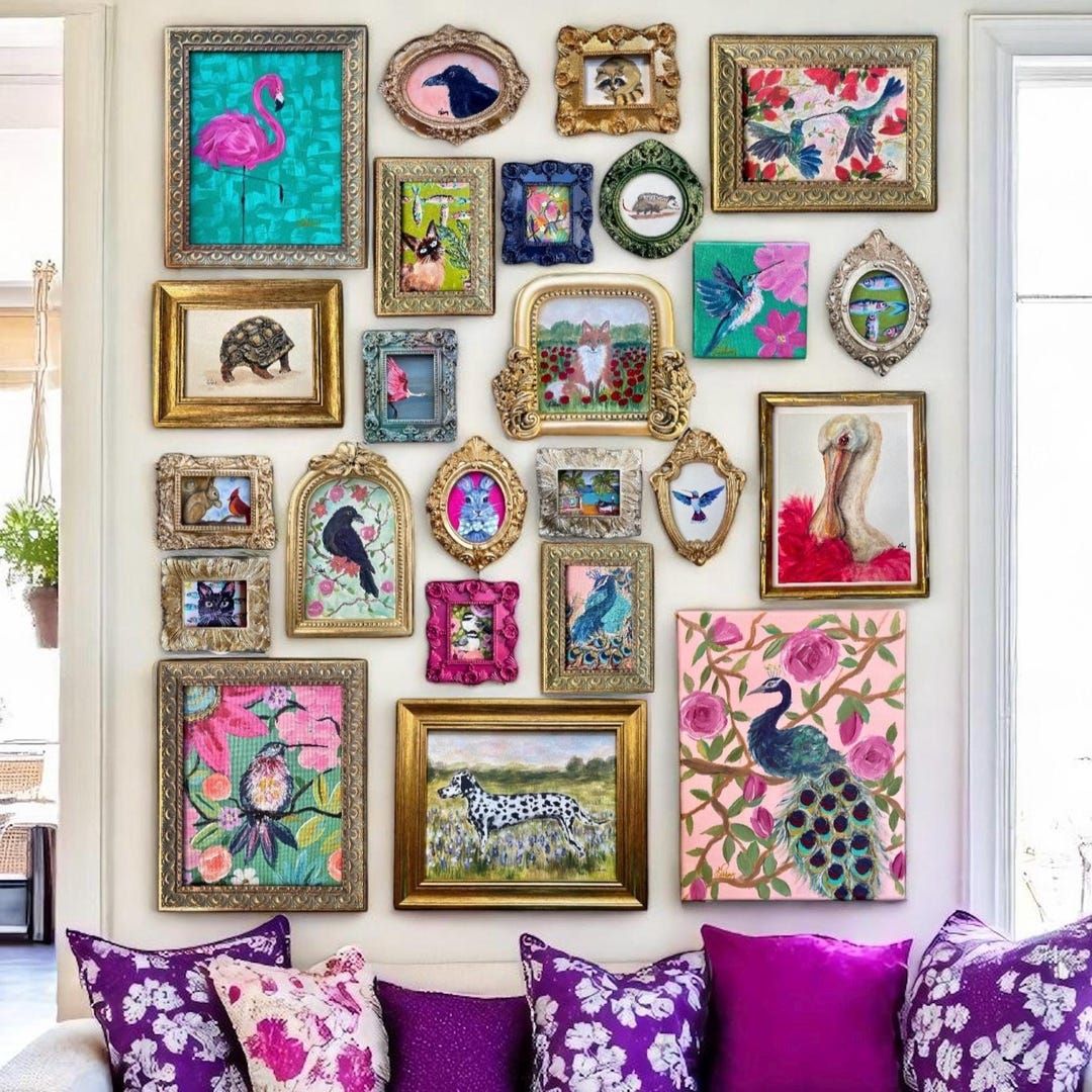 Colorful gallery wall with ornate frames above purple couch