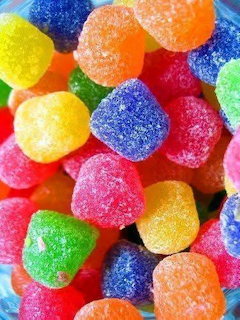 Close-up of colorful sugar-coated gumdrops in red, orange, yellow, green, and blue