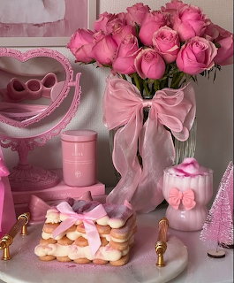 Pink vanity table with roses, heart mirror, pastries, and coquette decor