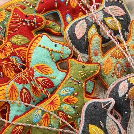 Colorful embroidered felt bird ornaments with beads and floral stitching