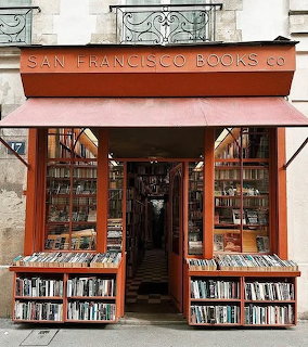 Orange-fronted San Francisco Books Co storefront with bookshelves and outdoor book displays