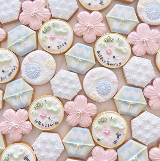 Overhead view of pastel decorated cookies with flowers and lace patterns