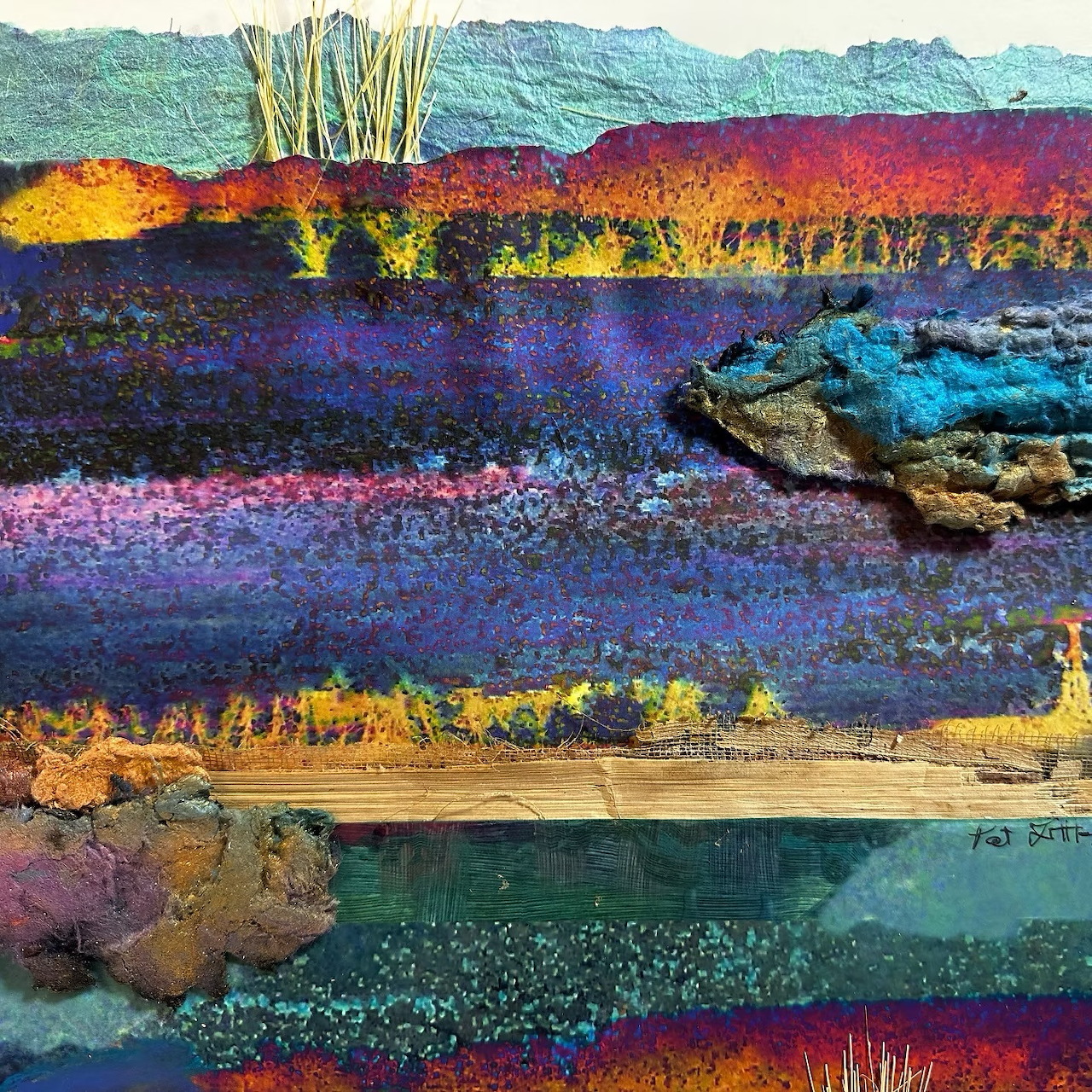 Colorful abstract fiber collage with layered purple, blue, and gold textured landscape bands