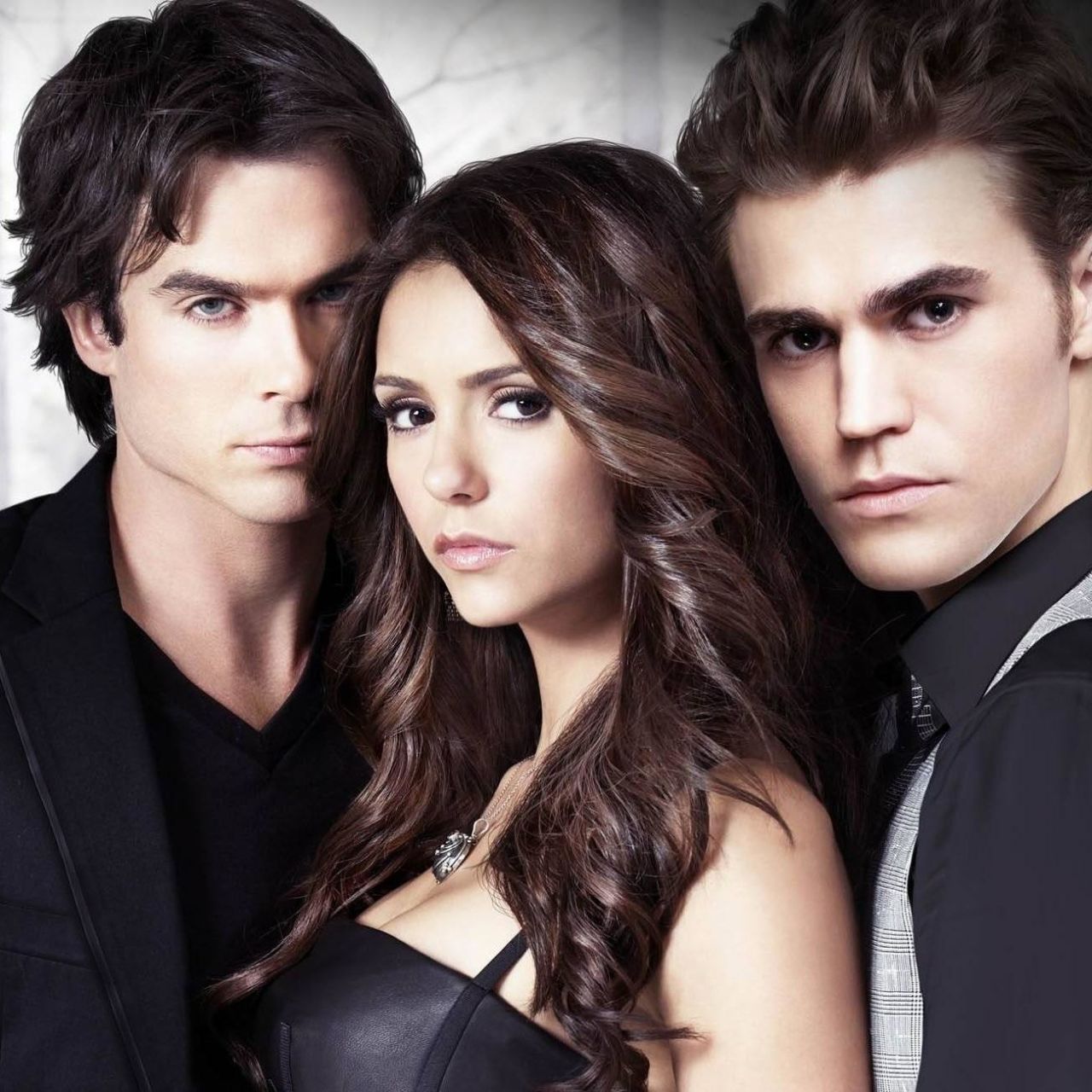 Studio portrait of three Vampire Diaries characters in dark formal clothing