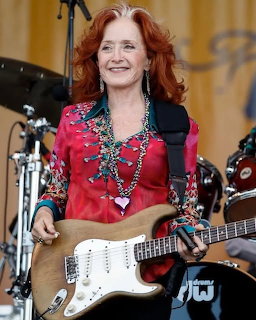 Red-Haired Woman Playing Guitar