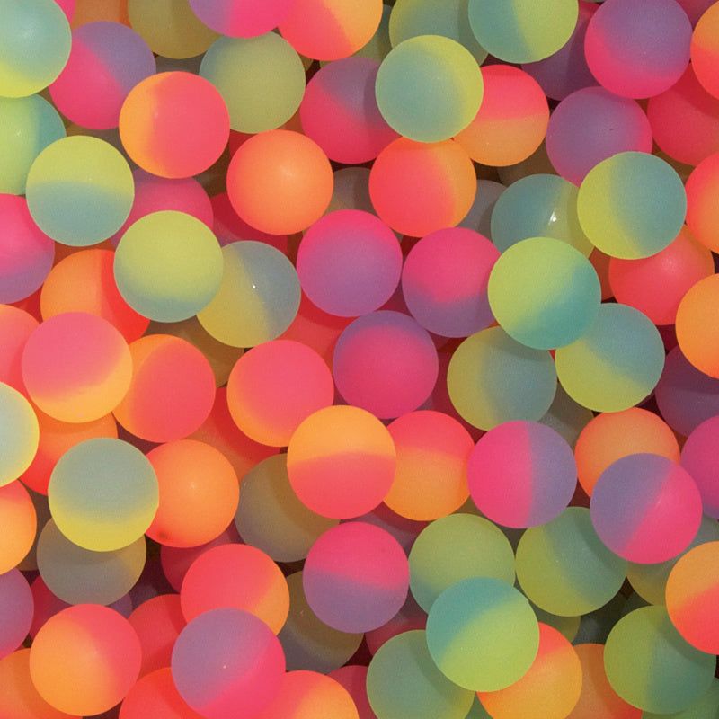 Close-up of many colorful neon bouncy balls filling the entire frame