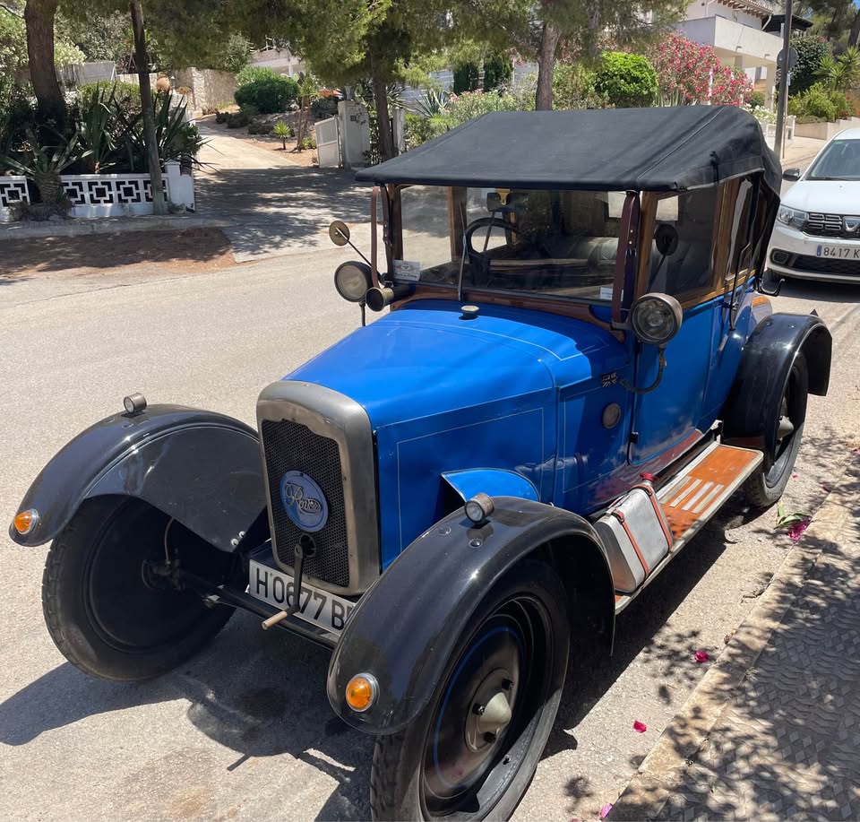 Blue 1921 Rover 8 vintage car parked on a street, seen from an elevated angle