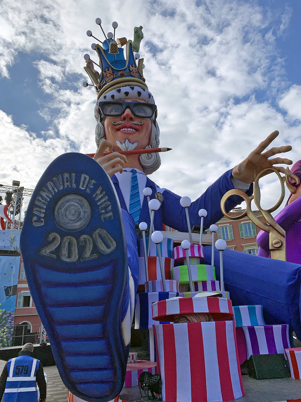 Colorful carnival parade float with costumed performers on a city street