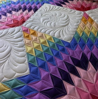 Colorful patchwork quilt with stitched fabric squares in geometric pattern
