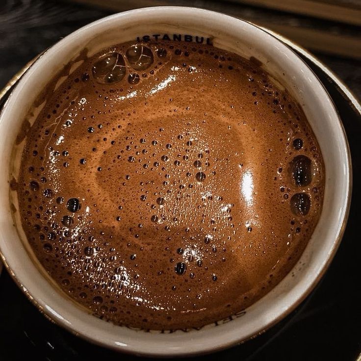 Top view of a cup of coffee with brown crema and bubbles