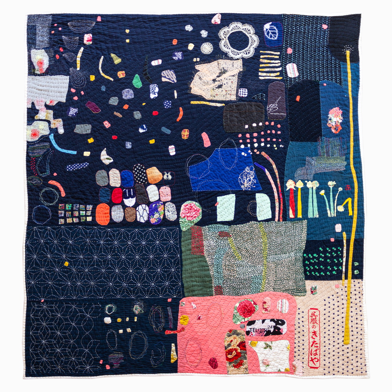 Abstract patchwork textile artwork with stitched patterns and colorful fabric blocks