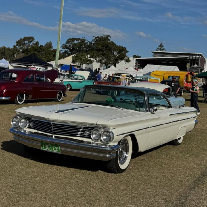 White vintage convertible car at outdoor classic car show