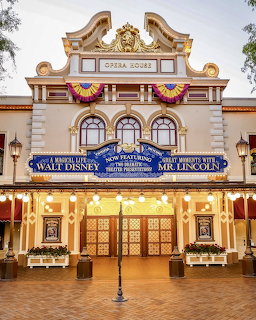Ornate theater building with patriotic decorations and vintage marquee at Disneyland theme park