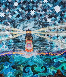 Colorful quilt artwork of a lighthouse shining beams into a starry night sky over turbulent ocean waves