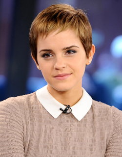 Portrait of Emma Watson with short hair, wearing a light sweater and white collar