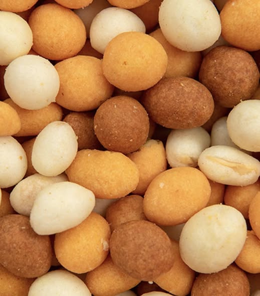 Close-up of mixed coated peanuts in white, golden, and brown colors