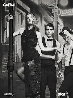 Black and white photo of fashion models posing dramatically on a nightime street set