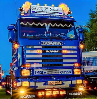 Blue Scania Super truck with chrome grille and decorative orange lights
