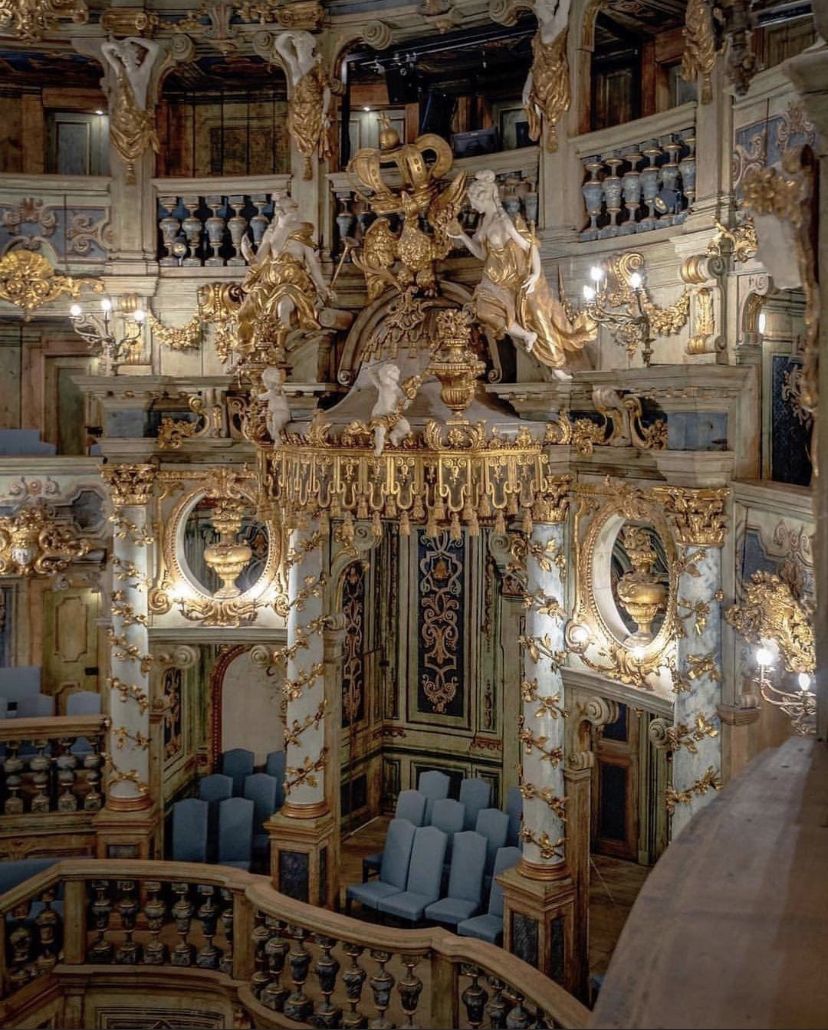 Ornate Baroque interior of the Margravial Opera House with gilded stucco carvings and tiered balconies