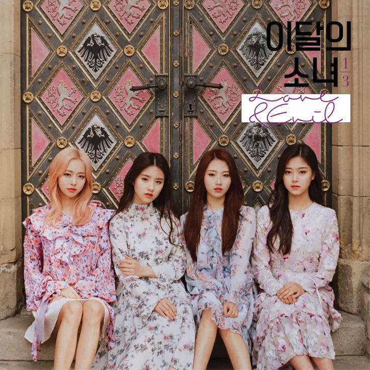 Four women in floral dresses seated before ornate patterned doors