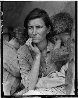 Black and white photo of a worried woman with two children leaning on her shoulders, Migrant Mother 1936