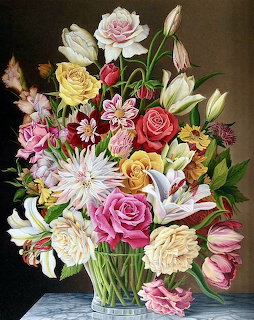 Colorful flower bouquet with roses, tulips and dahlias in a glass vase on dark background