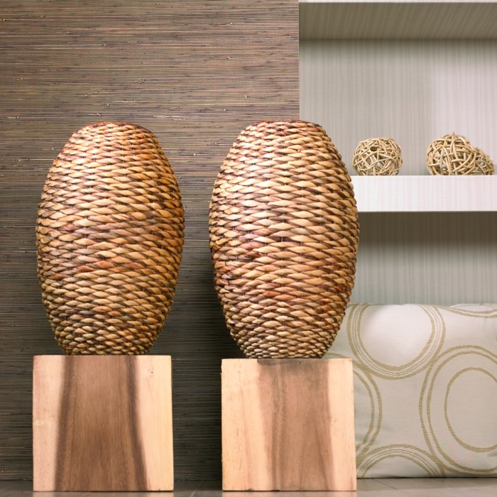 Two woven oval table lamps on wooden bases in a modern interior setting