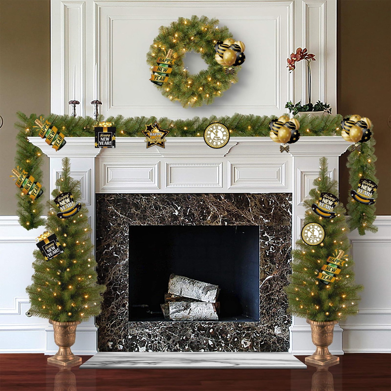Fireplace mantel decorated with Christmas wreath, garland, clocks, ornaments, and two small lit trees