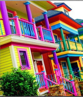 Row of brightly painted colorful houses with porches and vivid trim