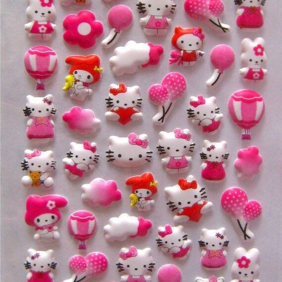 Assorted Hello Kitty figures and pink Valentine's Day decorative charms scattered on white surface