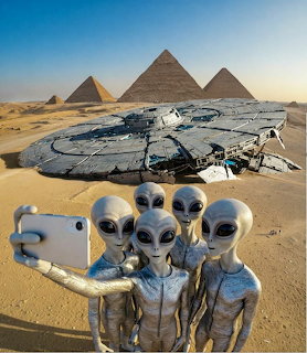 Two grey aliens posing for a selfie beside a crashed UFO on an alien landscape