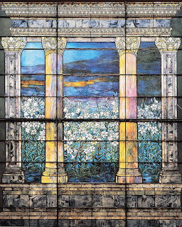 Tiffany-style stained glass window with columns, white lilies, and a blue mountain landscape
