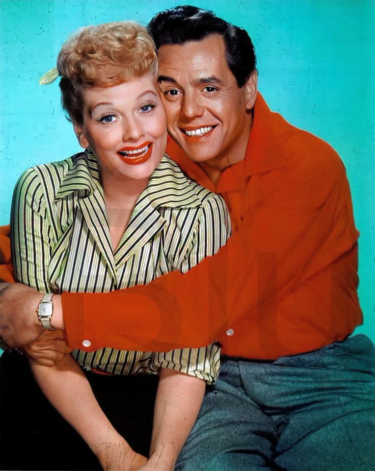 Lucille Ball and Desi Arnaz smiling together in a vintage color portrait against a teal background