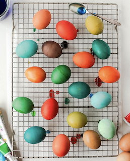 Colorful dyed Easter eggs on a wire cooling rack viewed from above