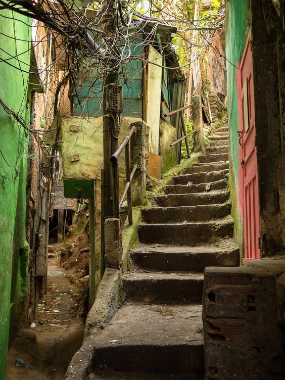 Narrow stone staircase in an old alley between colorful walls and buildings