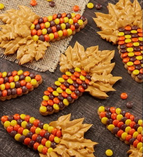 Decorated harvest-themed sugar cookies in autumn shapes and colors