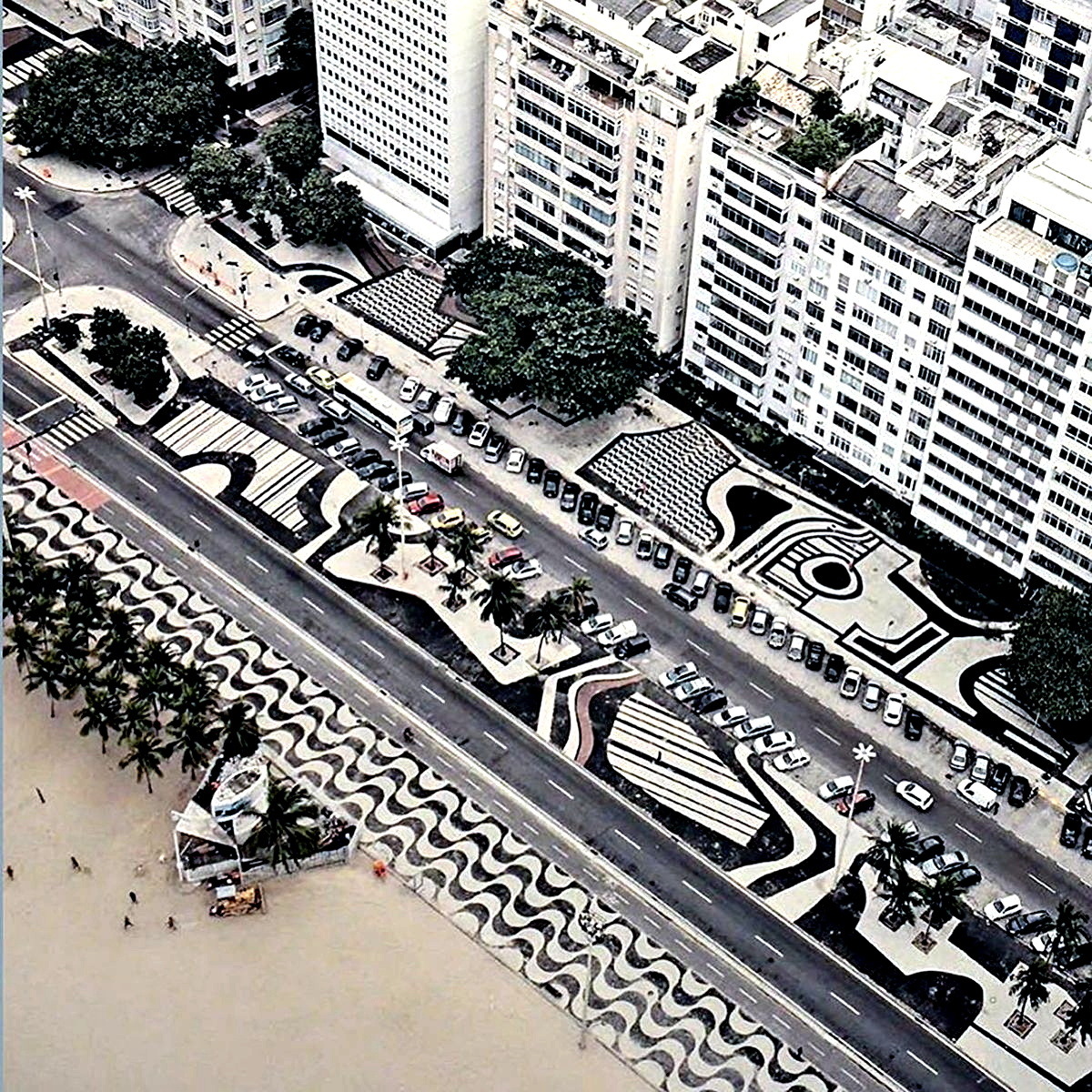Aerial view of Copacabana promenade with black and white mosaic waves beside the beach and buildings