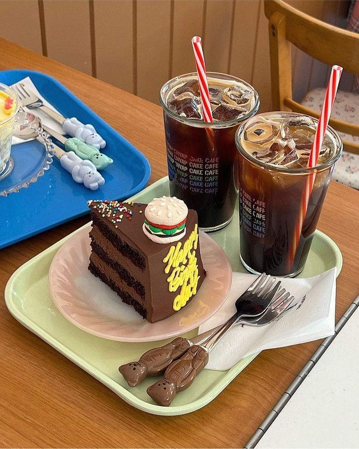 Iced americano coffees and chocolate cake on a cafe table