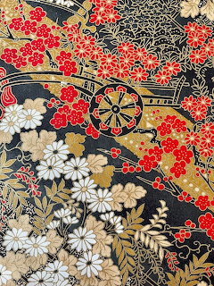 Japanese textile pattern with flower cart and cherry blossoms on black background with gold details