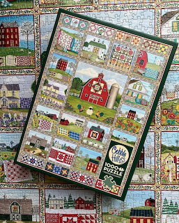Puzzle box with colorful farm quilt illustrations on a matching patchwork background