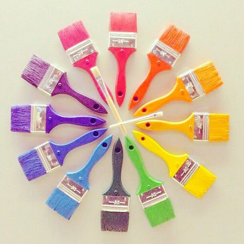 Paint brushes in rainbow colors arranged in a circular pattern