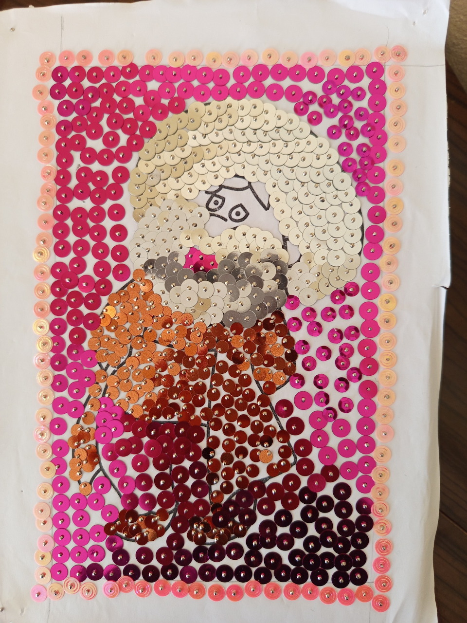 Sequin art portrait of Nasreddin Hoca with pink border and silver halo on white fabric