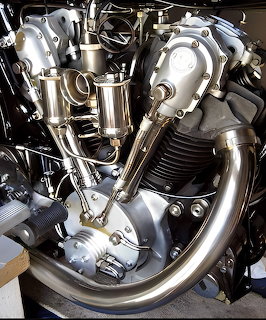 Close-up of 1927 Koehler-Escoffier K100 vintage motorcycle engine with chrome cylinders and exhaust pipes