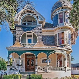 Ornate Victorian house with turret, arched porch, and decorative trim