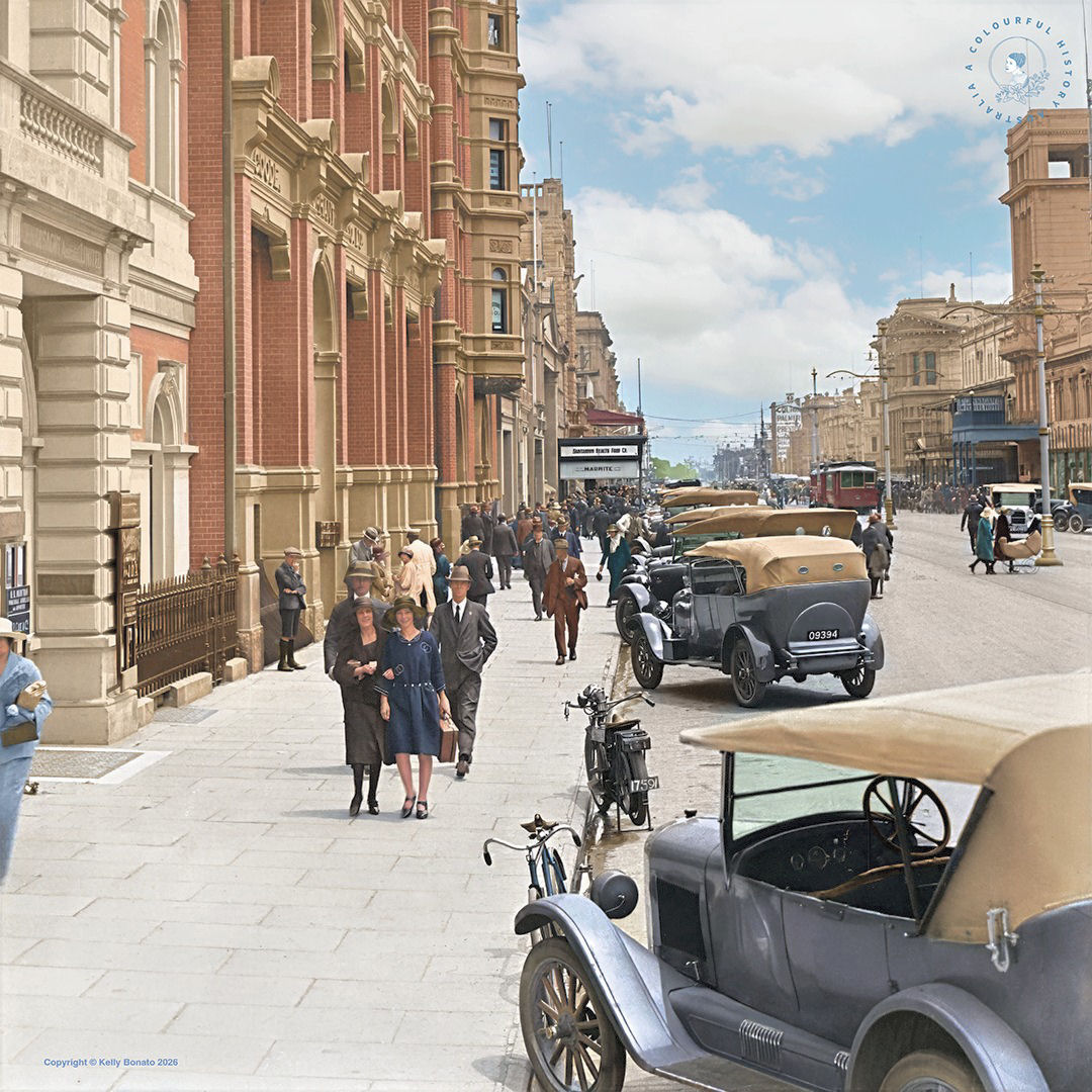 Historic Grenfell Street in Adelaide with vintage cars, pedestrians, and old city buildings