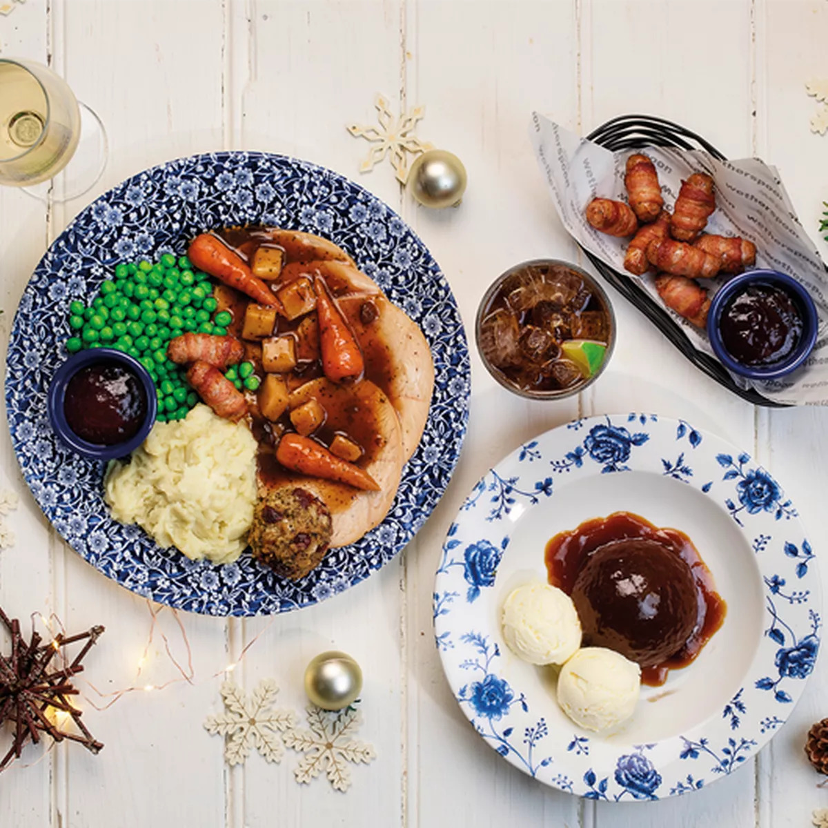 Christmas dinner plated with roasted turkey, vegetables, peas, stuffing, and gravy on blue patterned plates