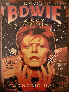 Vintage David Bowie Ziggy Stardust concert poster with a stylized portrait and starry background