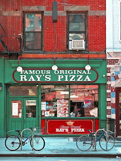 Ray's Pizza restaurant exterior with green awning and brick building in Manhattan