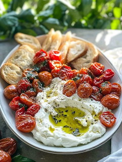 Burrata cheese with roasted tomatoes and flatbread on white plate