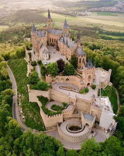 Aerial view of Hohenzollern Castle on a hill surrounded by forest and fields